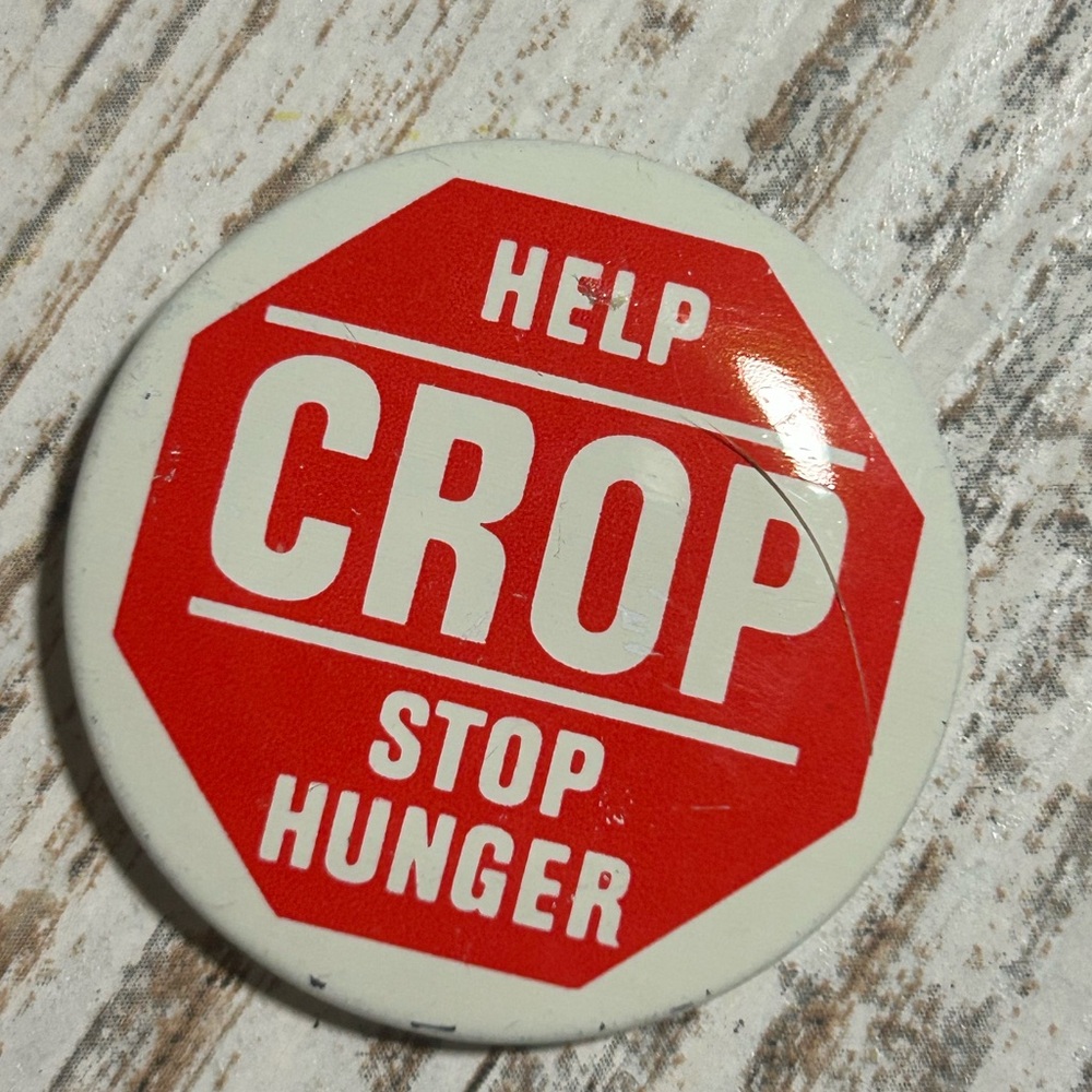 Vintage 1970s "Help CROP Stop Hunger" pin-back button, featuring a stop sign